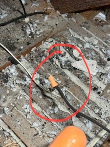 Wire nut on old wiring with burn marks in attic