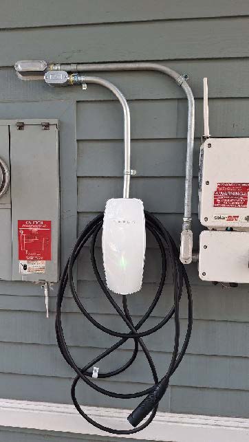 Residential EV charger installation mounted on exterior wall