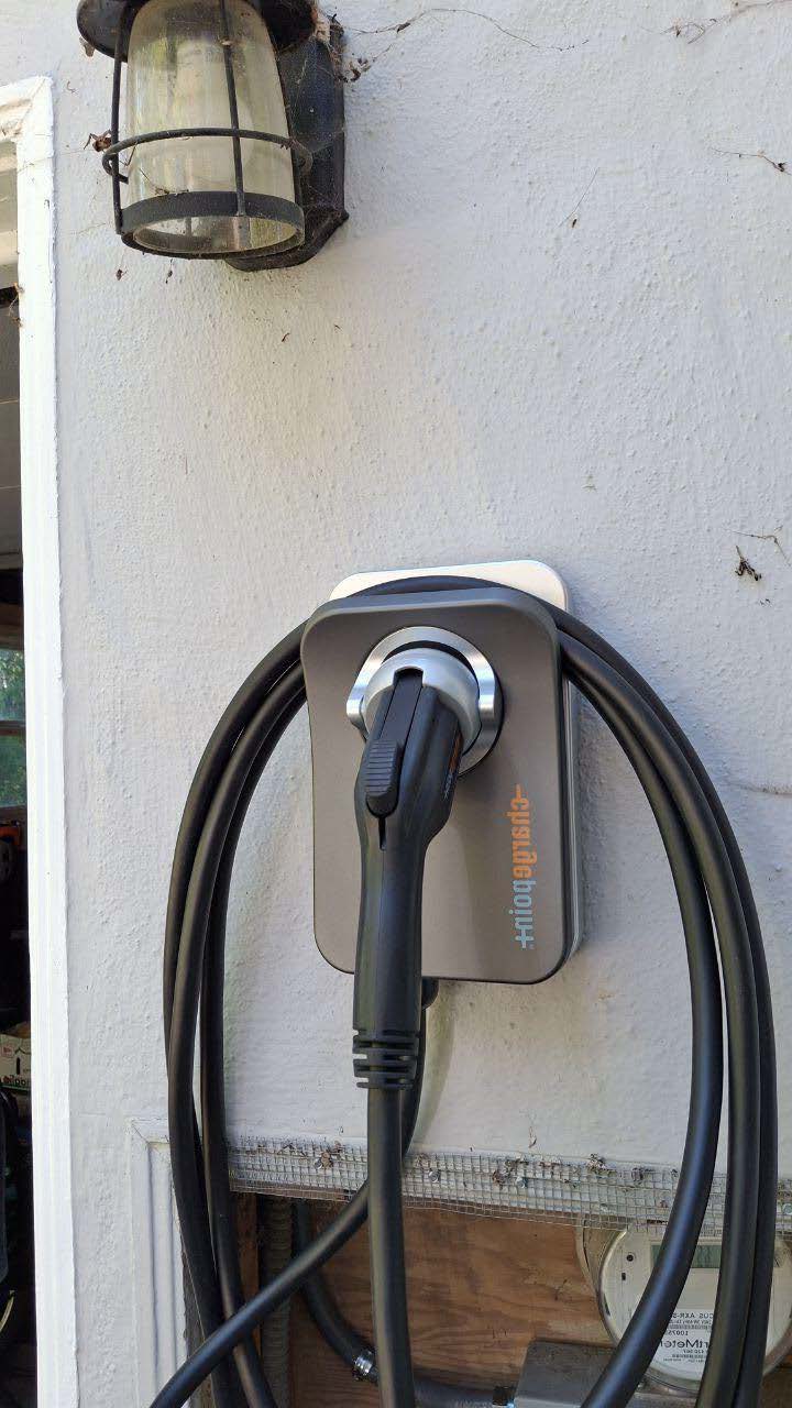 Wall-mounted EV charger installed outside home