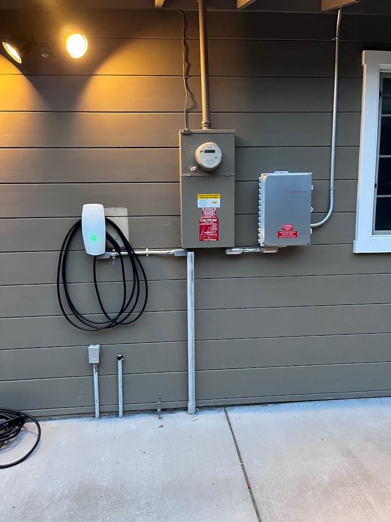 Finished EV charger installation on exterior residential wall