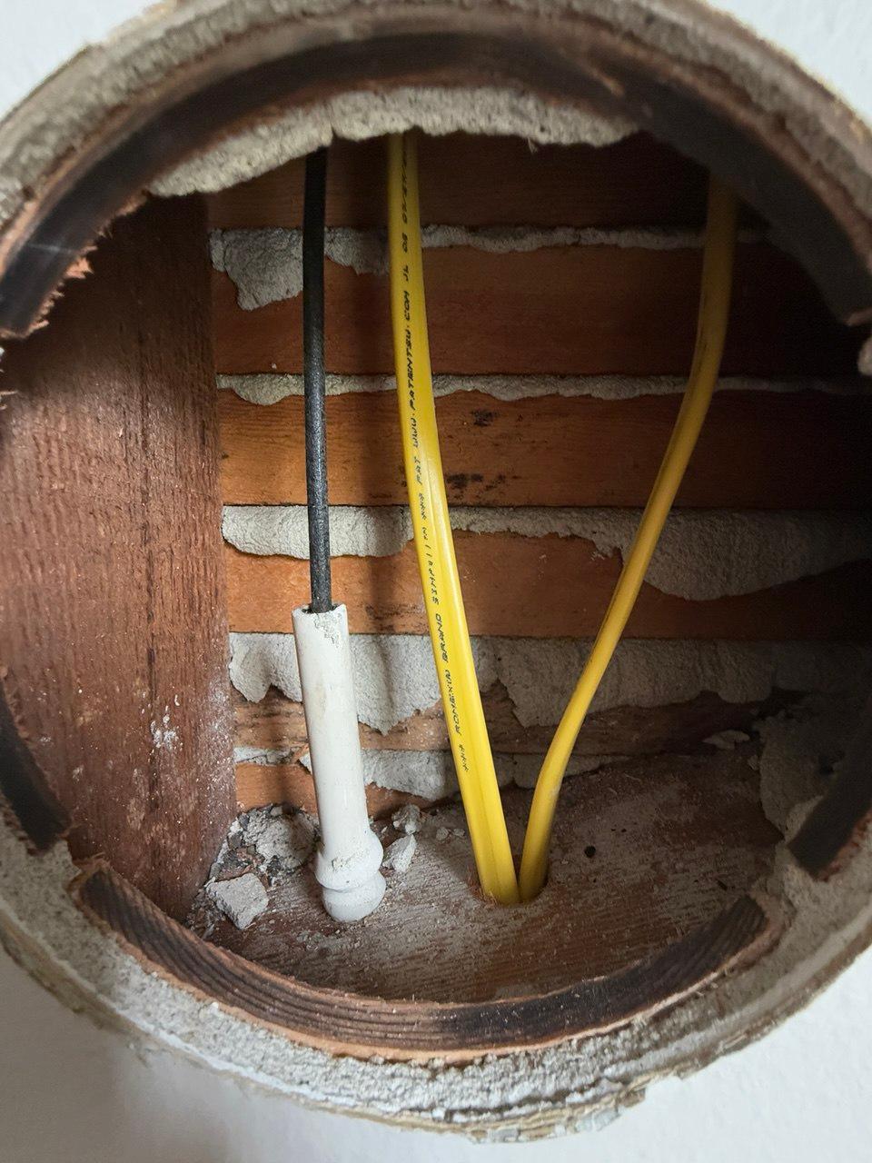 Wall opening with updated wiring during knob-and-tube replacement