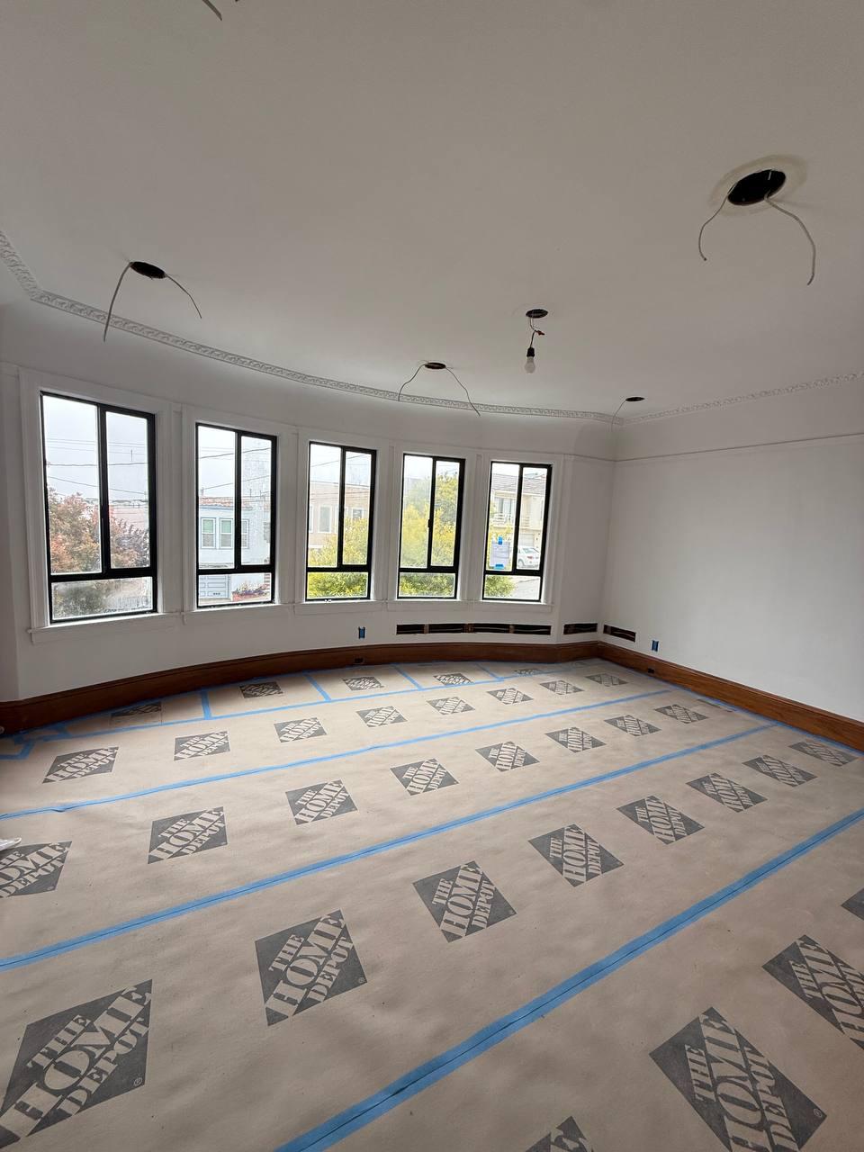 Large room prepared during full knob-and-tube rewiring project in Alameda