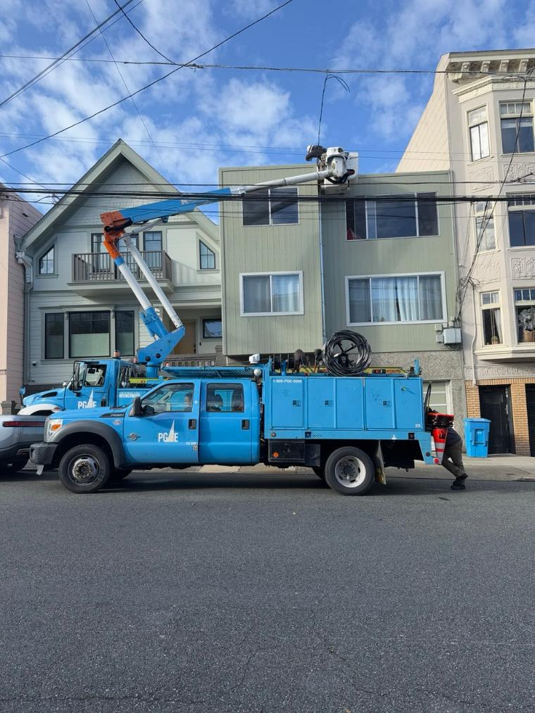 Utility truck outside San Francisco building during electrical service upgrade project