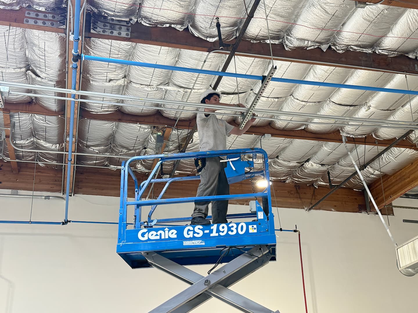 Ceiling conduit installation in manufacturing facility
