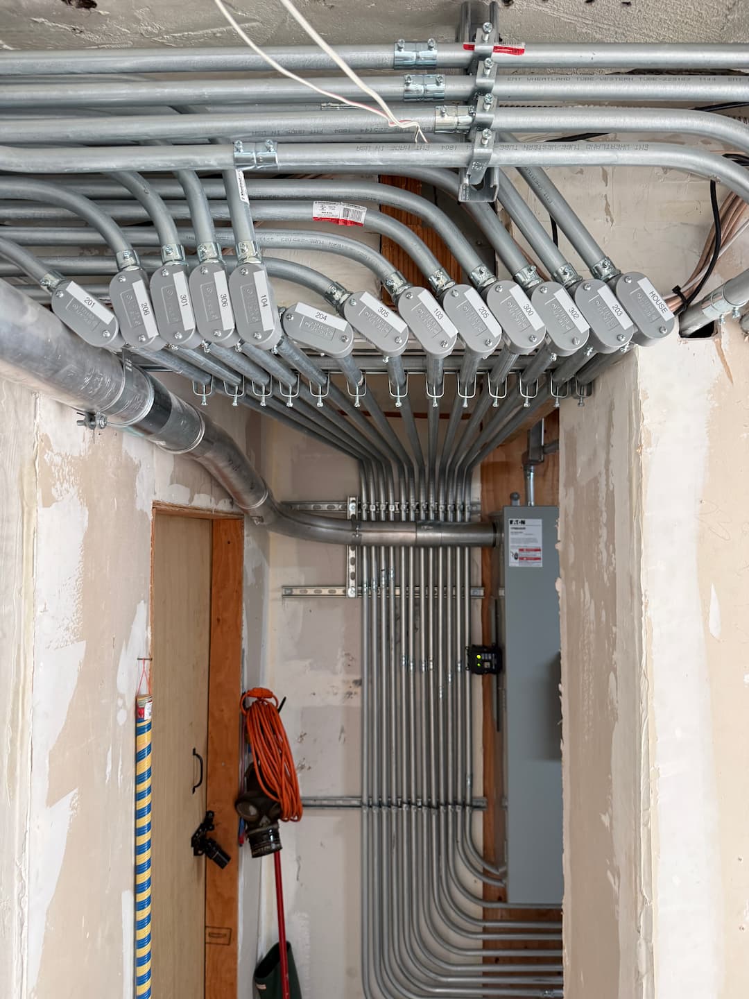 Finished electrical room conduit routing for 16-unit building