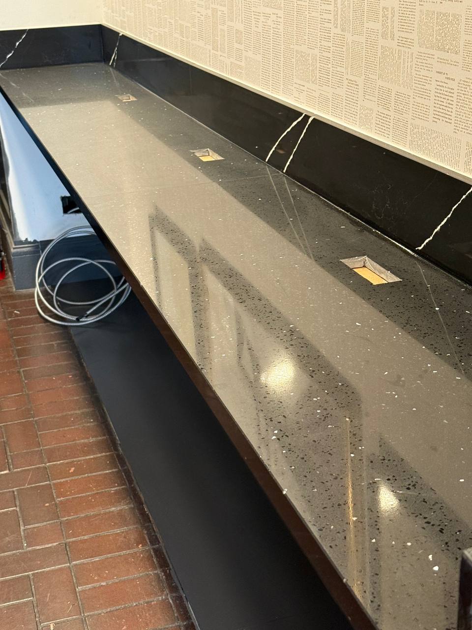 Outlet installation along a stone countertop in a historic hotel renovation