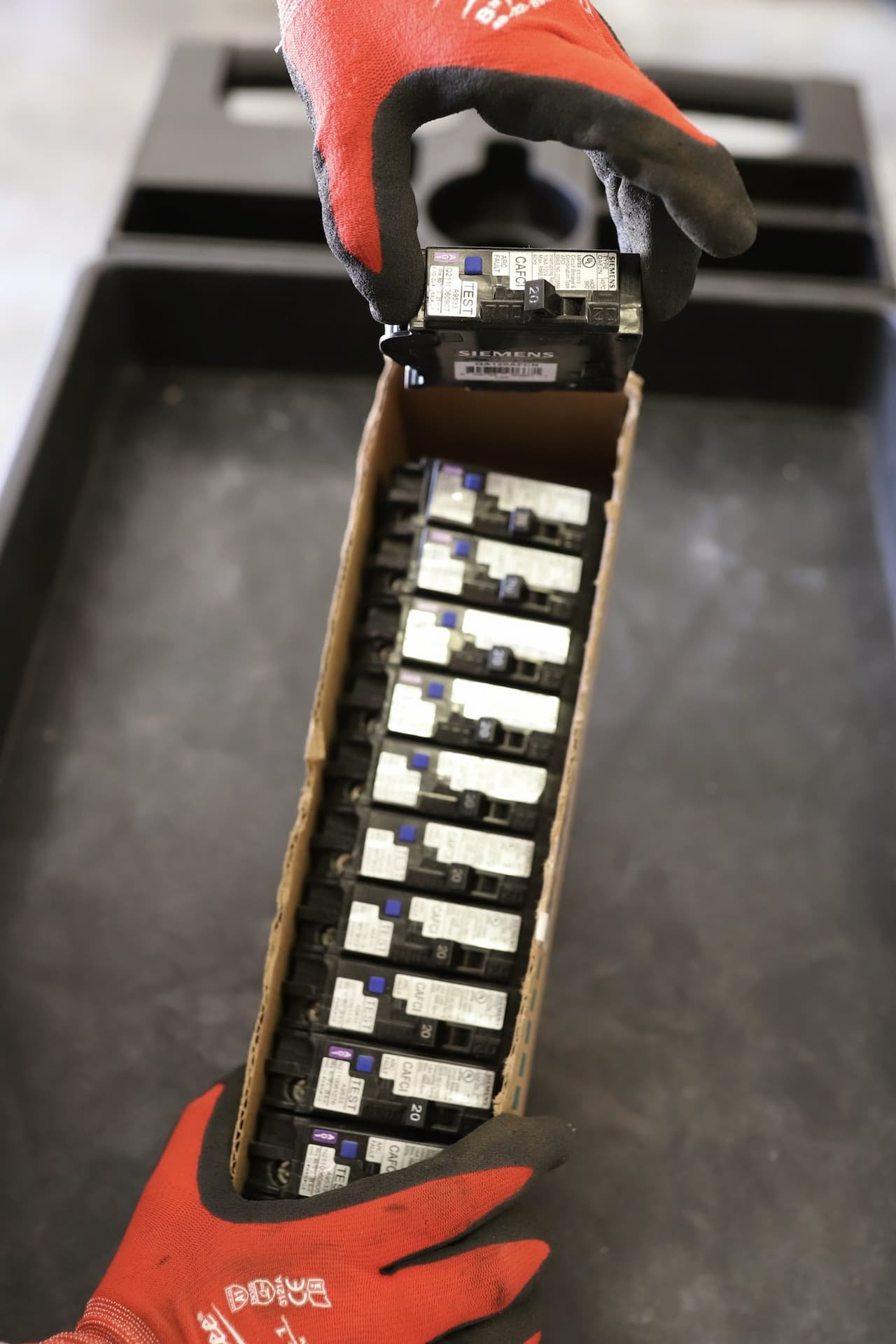 MaxElectric electrician handling new circuit breakers