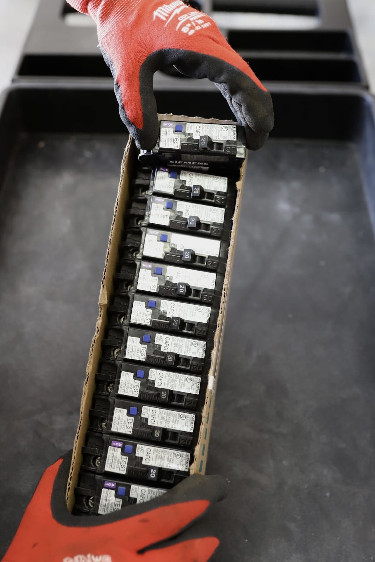 Electrical Panel Safety Work by MaxElectric MaxElectric technician handling CAFCI breakers for electrical panel work