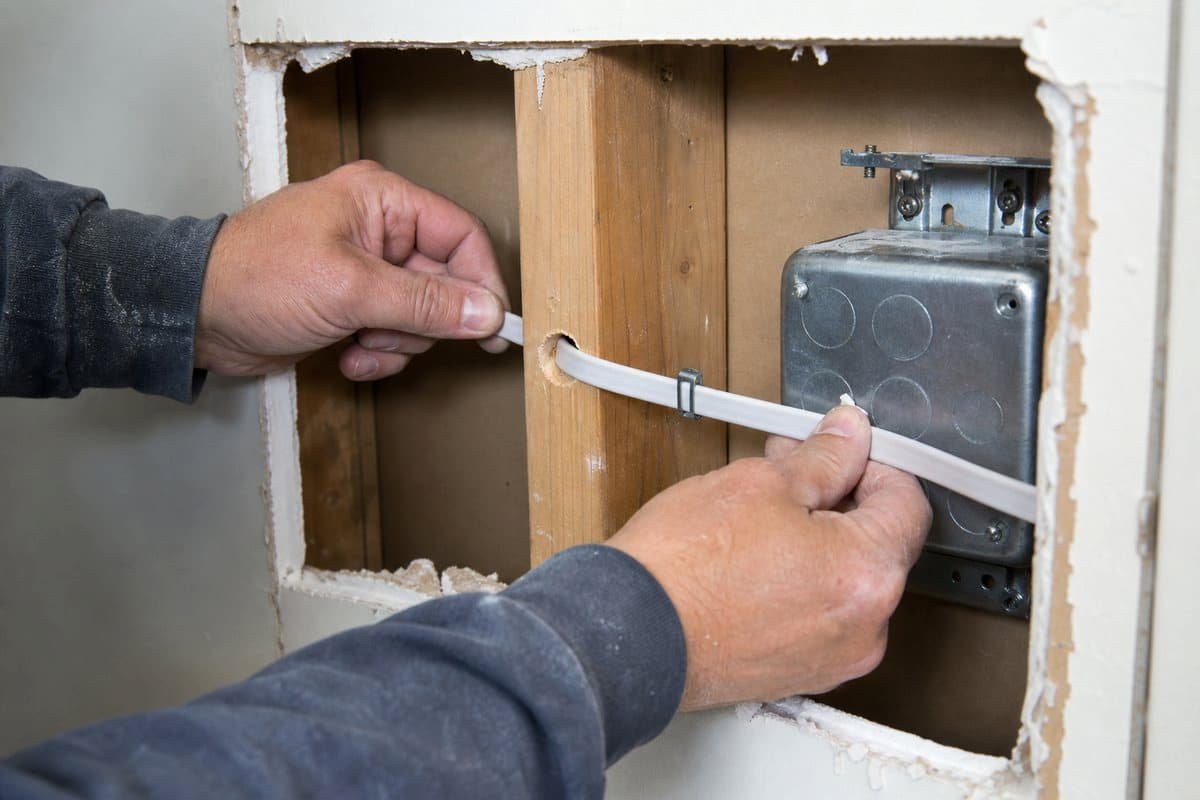 New electrical wiring installed through open wall framing