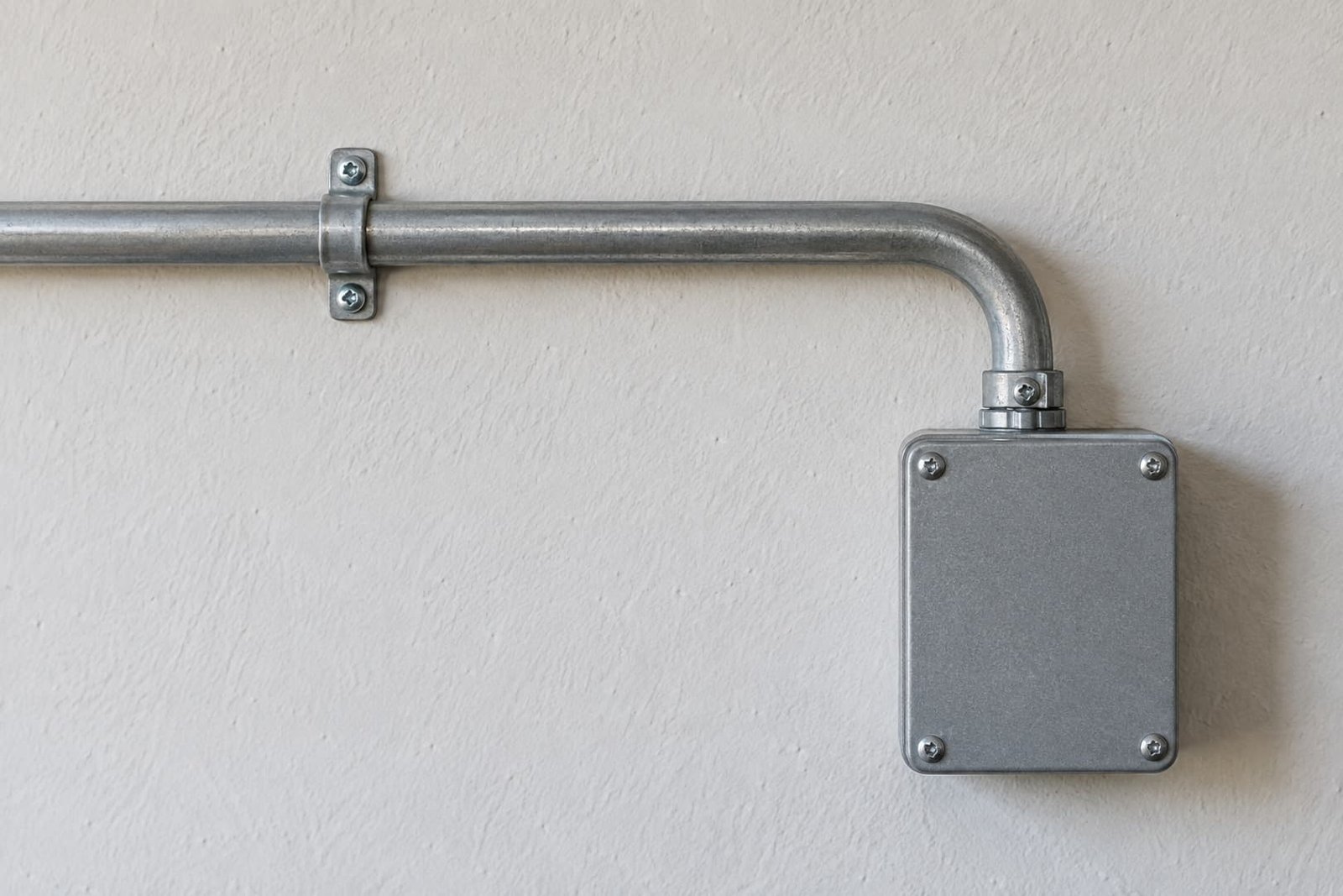 Orderly surface conduit route on a garage wall