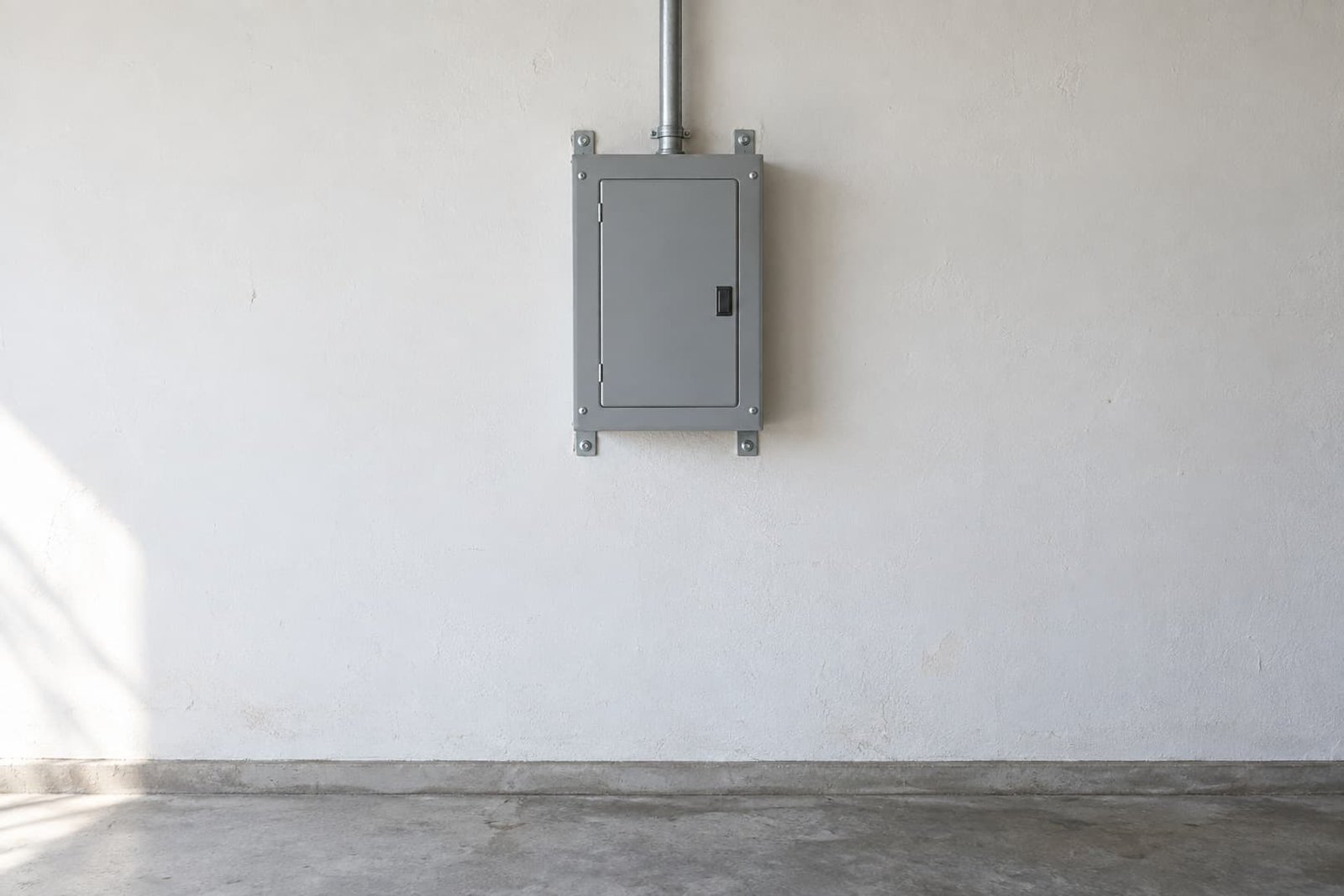 Garage subpanel with a surface conduit route